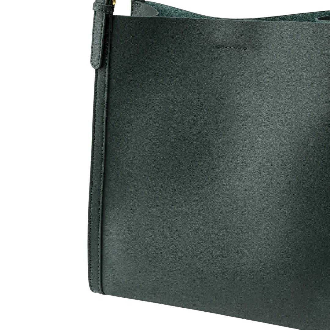 A close-up view of a dark green leather tote bag with a zipper closure.