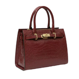 A burgundy leather handbag with a crocodile skin texture and gold hardware, including a lock and clasp.