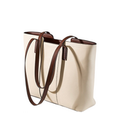 A tan leather tote bag with brown leather straps and handles.