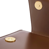 a close-up view of a brown leather wallet or purse with a gold-colored clasp.
