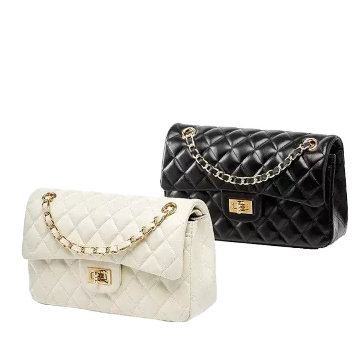 two handbags, one white and one black, with gold chain straps and buckles.