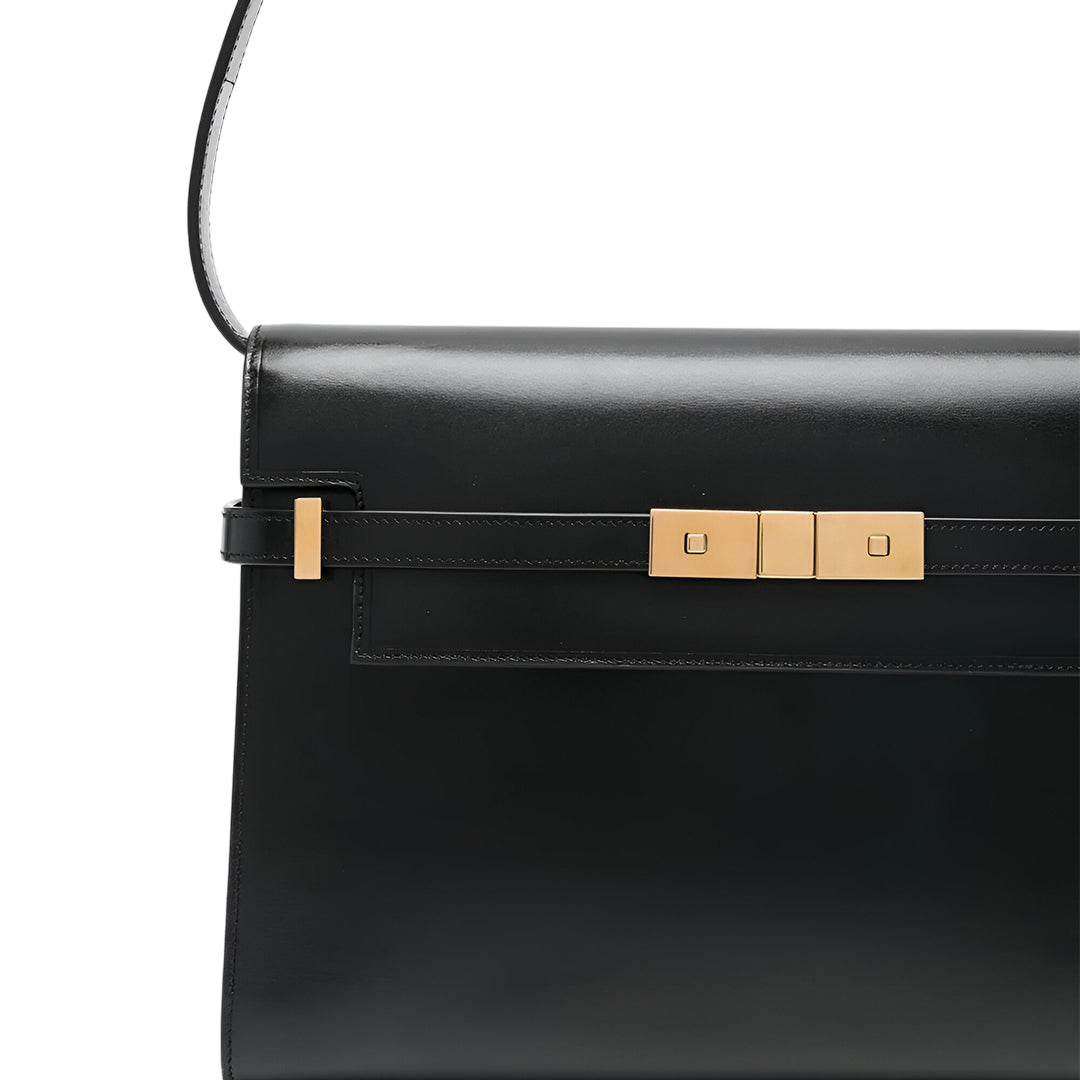 A black leather handbag with a gold-colored buckle detail.
