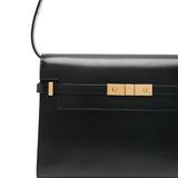A black leather handbag with a gold-colored buckle detail.