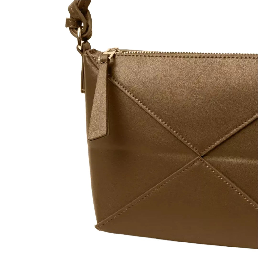 A close-up view of a brown leather handbag with a zipper closure and a small handle.
