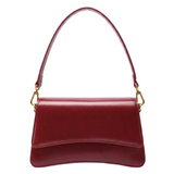 A red leather handbag with a curved handle and gold hardware.