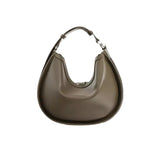 A brown leather handbag with a curved shape and a metal clasp on the top.