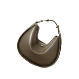 A brown leather handbag with a curved shape and a zipper closure.