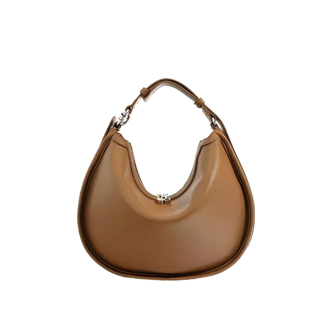 A tan-colored handbag with a curved shape and a handle.