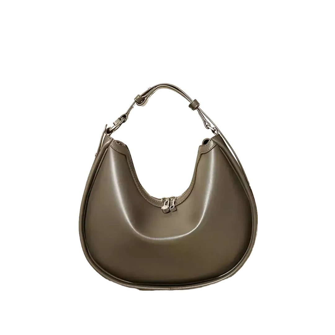 A brown leather handbag with a curved shape and a handle.