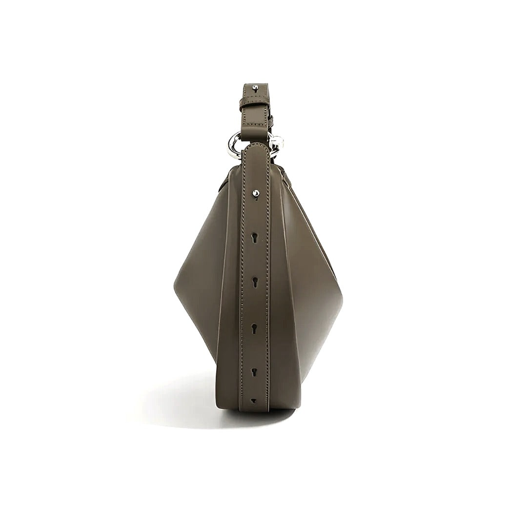 A brown leather handbag with a geometric shape and metal hardware.