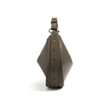 A brown leather handbag with a geometric shape and metal hardware.