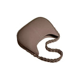 A brown leather handbag with a braided strap.