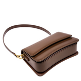A brown leather handbag with a curved top and a gold clasp.