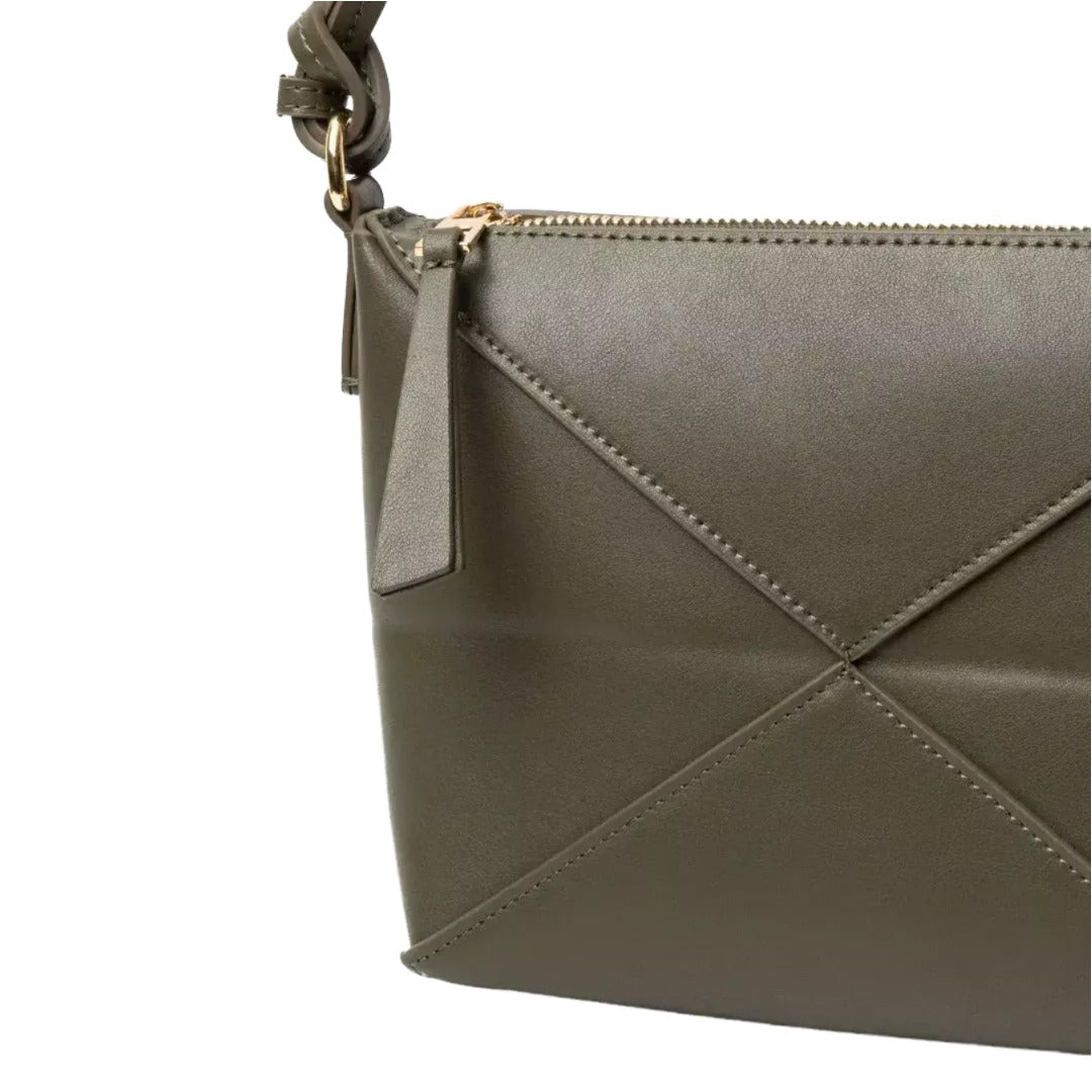 A close-up view of a brown leather handbag with a zipper closure and a small handle.