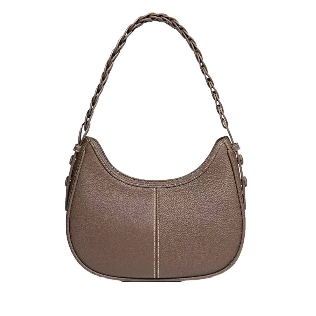 A brown leather handbag with a curved shape and a braided strap.