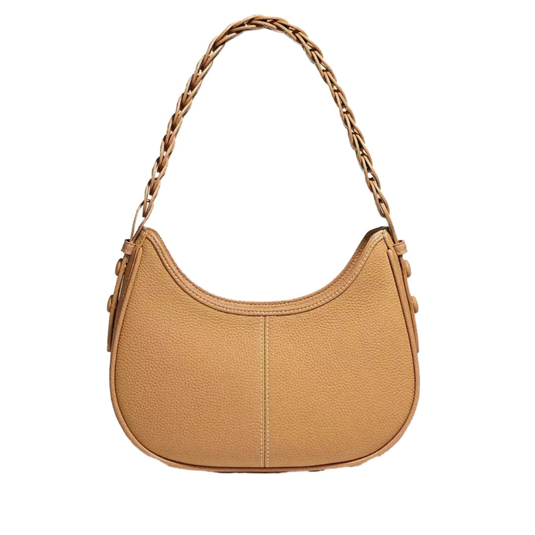A tan leather handbag with a curved shape and a chain strap.